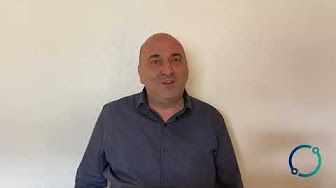 Image of man sitting in front of white wall